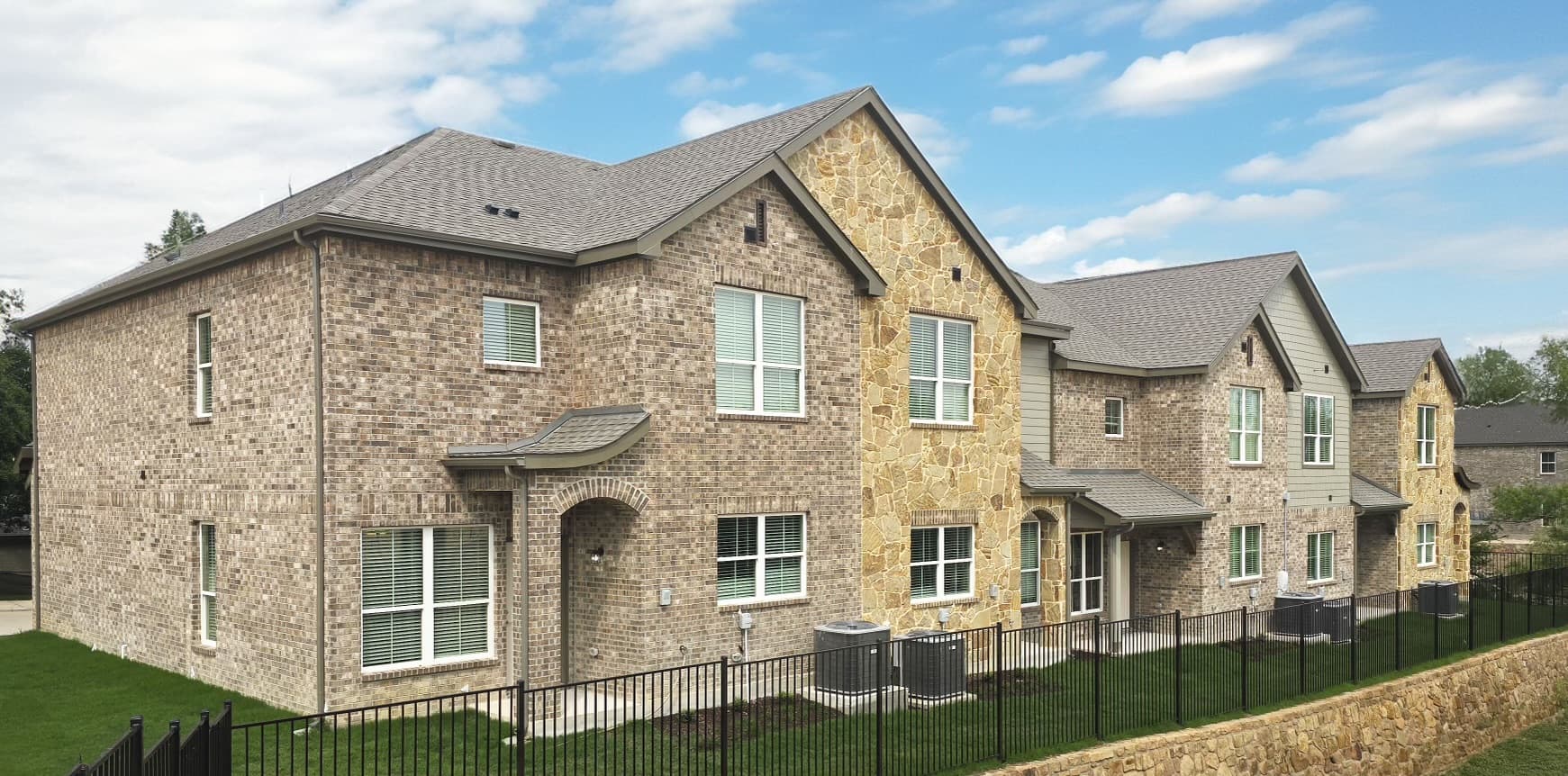 Brick-and-stone townhome exteriors at Stone Lake